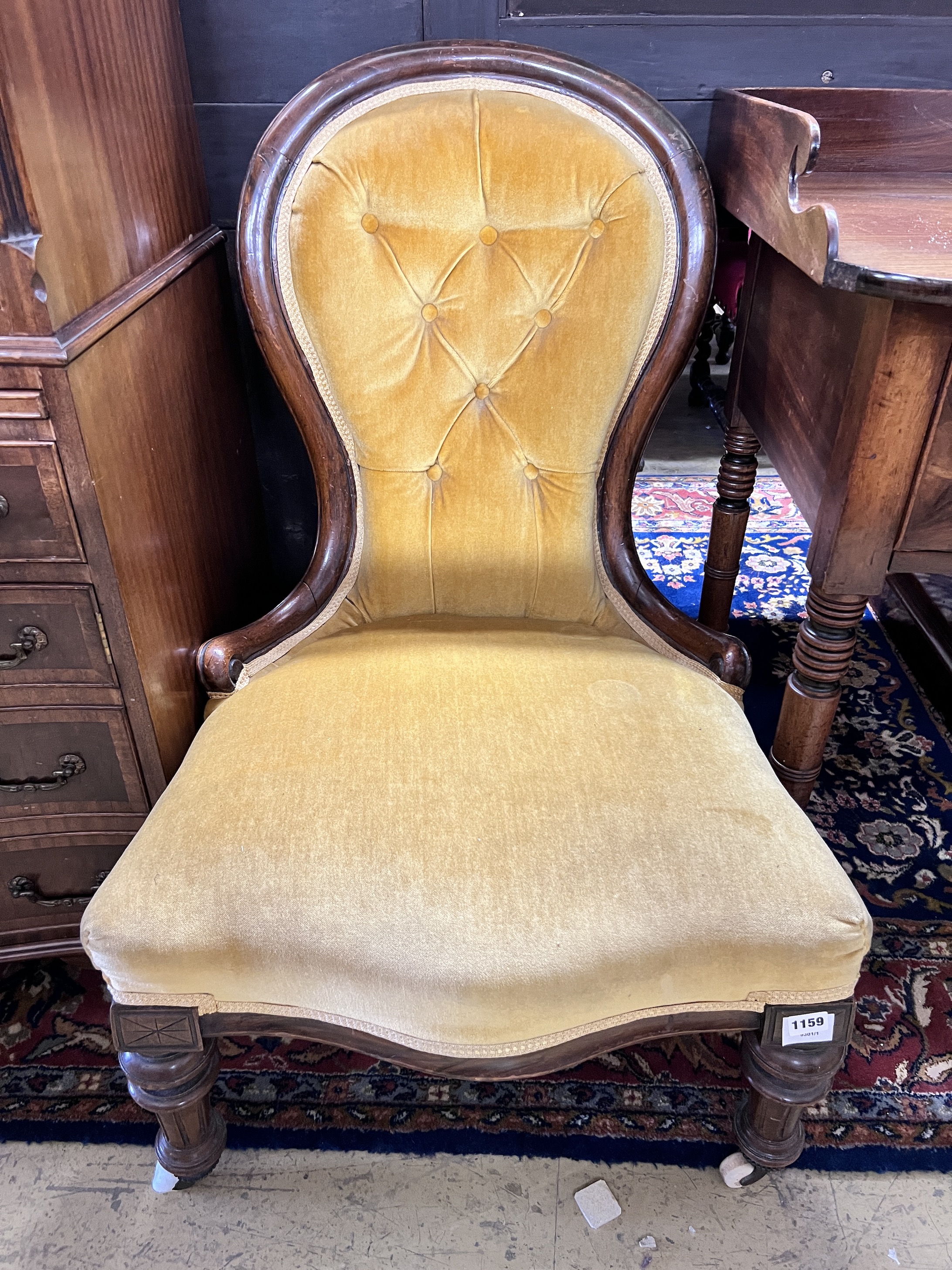 A Victorian mahogany spoonback nursing chair